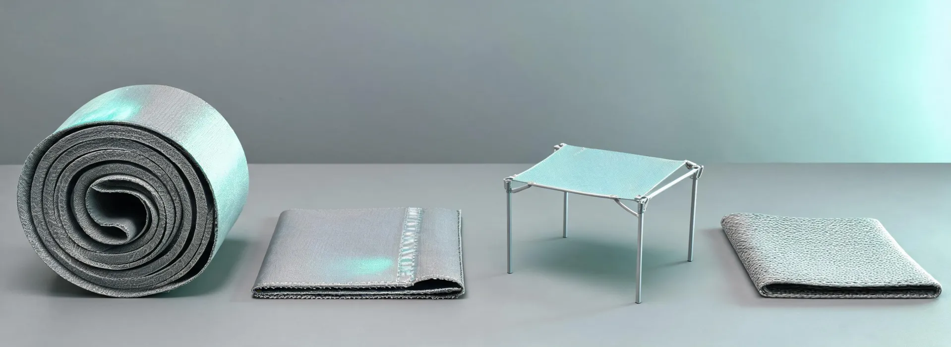Coated membrane roll beside a modular structure and outdoor furniture sample
